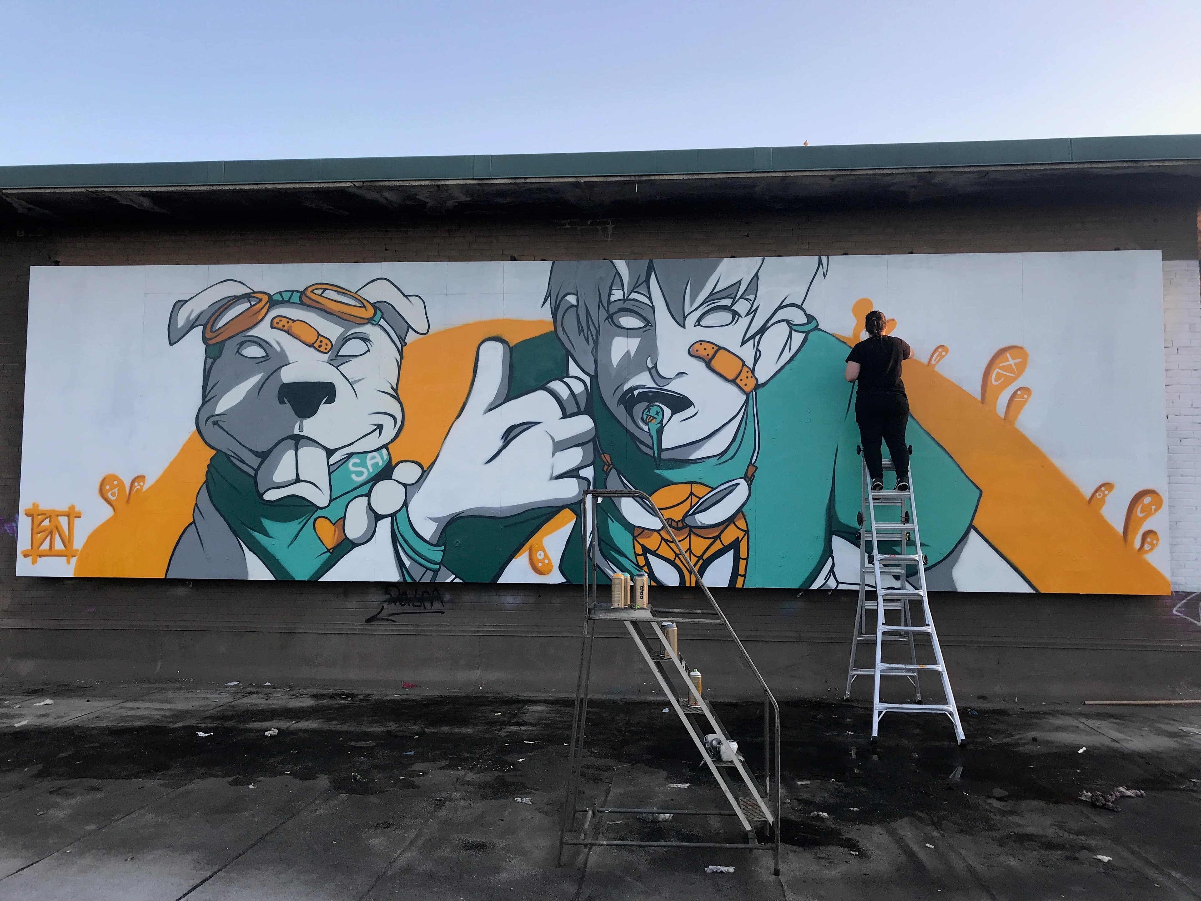 Rachel Nurmi working on a large-scale mural